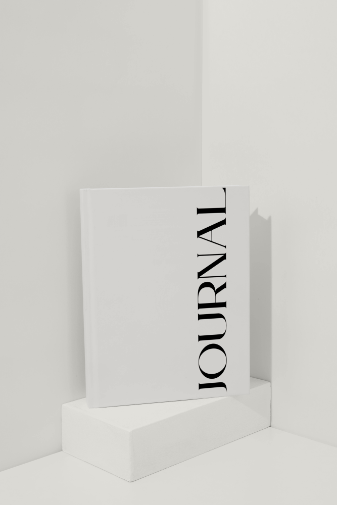 White journal with 'JOURNAL' text on a white background