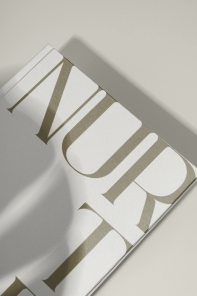 Close-up of a book with 'NUR' text on a light background